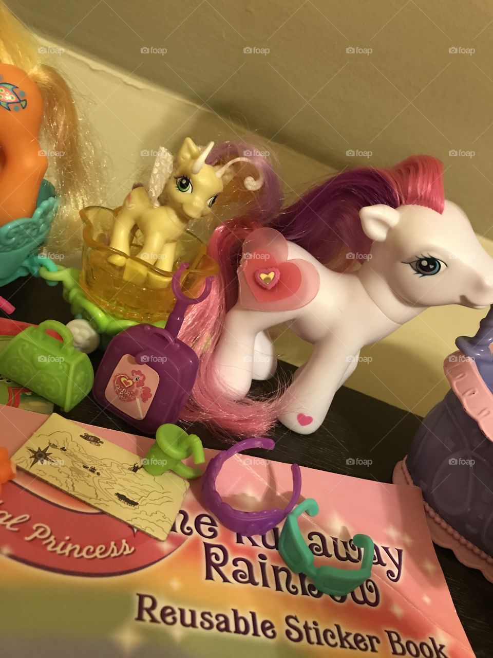 Several colorful My Little Pony toys from the 2000s to current