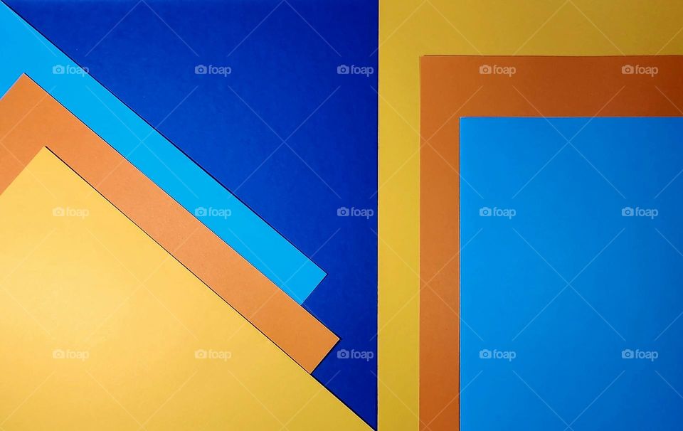 Geometric orange and blue complementary colours flatlay made with coloured papers