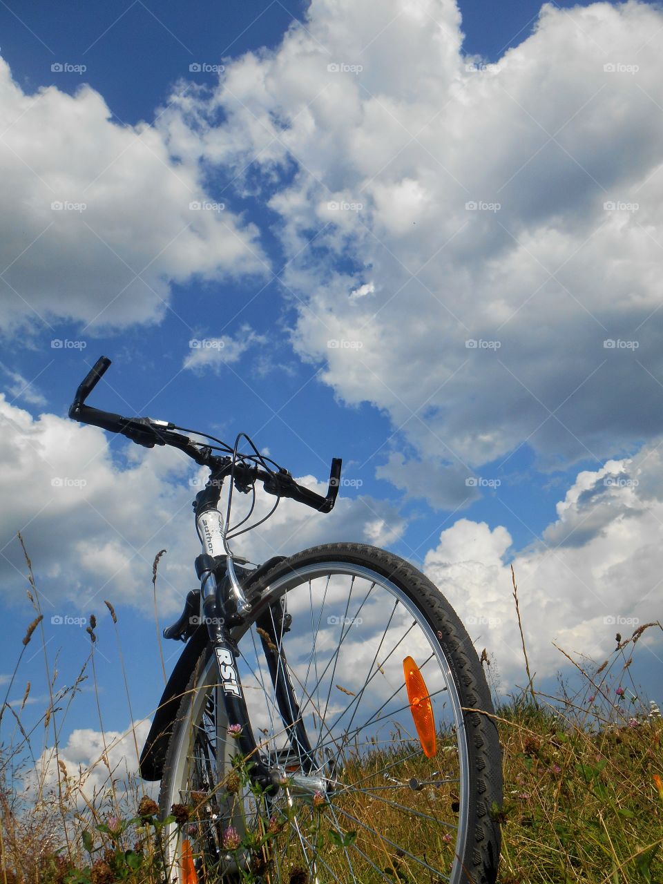 bike on a blue sky clouds background summer time