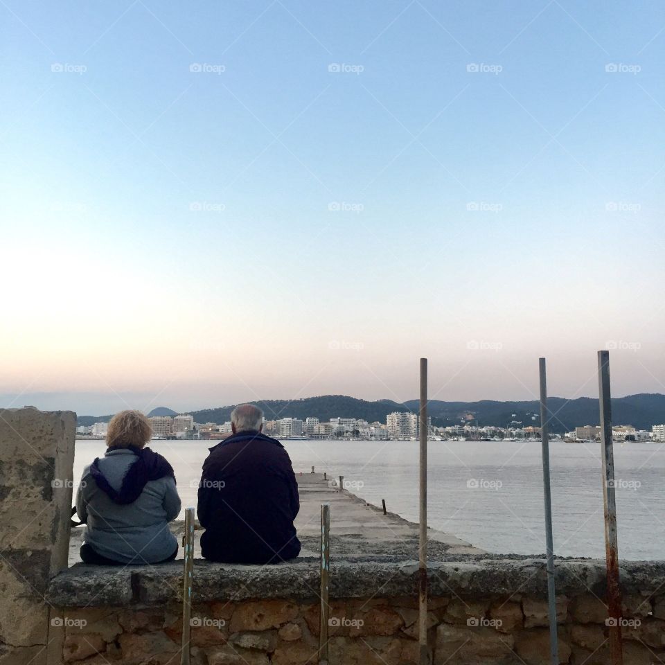 Elderly couple sitting on the bench 