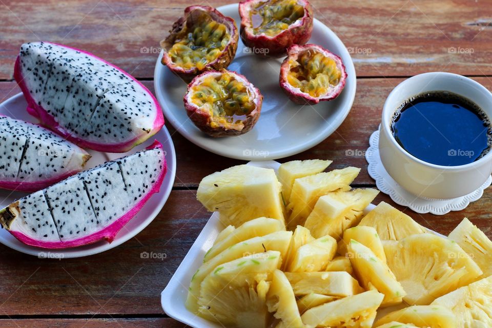 Healthy breakfast with exotic fruits and a cup of coffee 