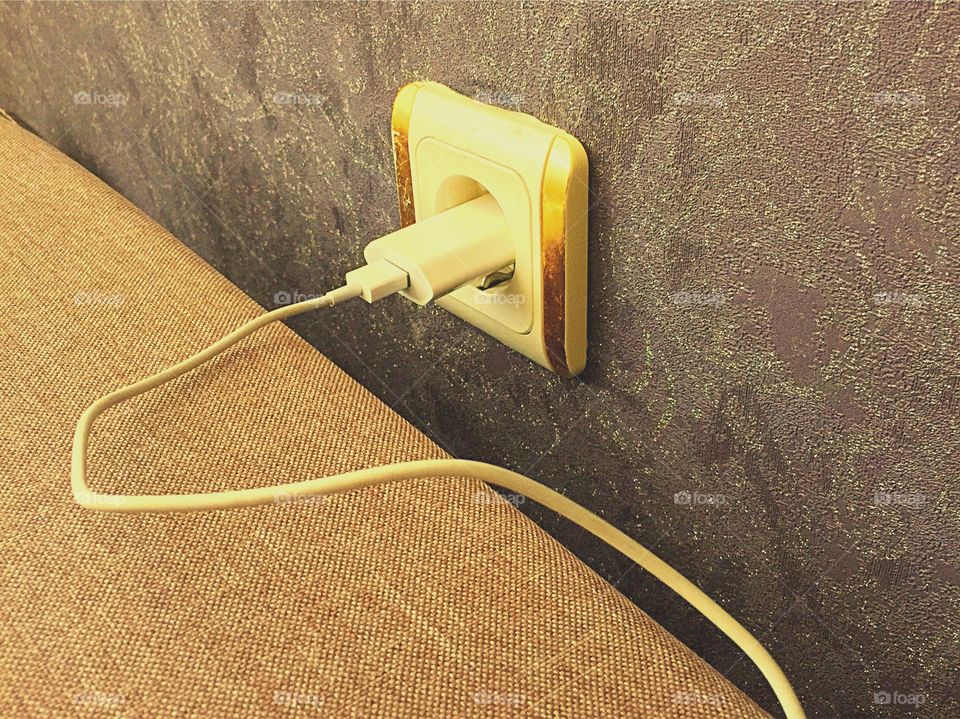 Mobile charger plug on wall
