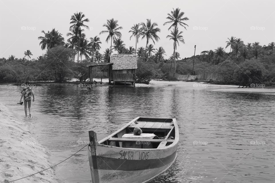 A small old house on the beach and a small boat