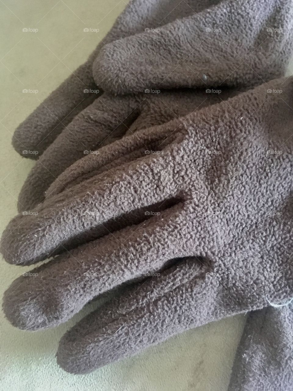 Old, fuzzy, brown winter gloves. 