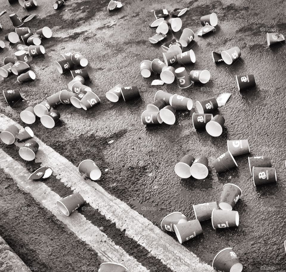 Aftermath of Brighton marathon . Cups beside the road after marathon