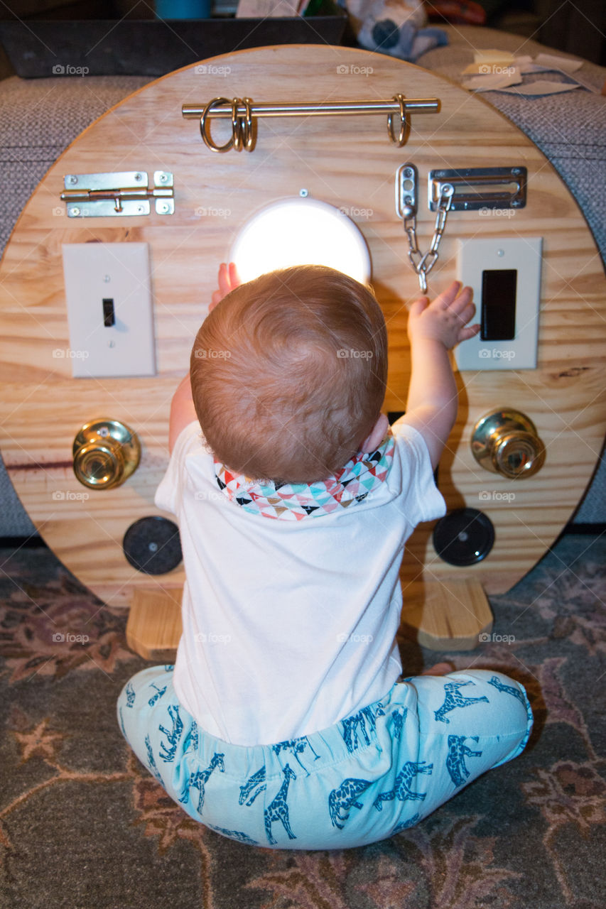 Little boy playing with door knob