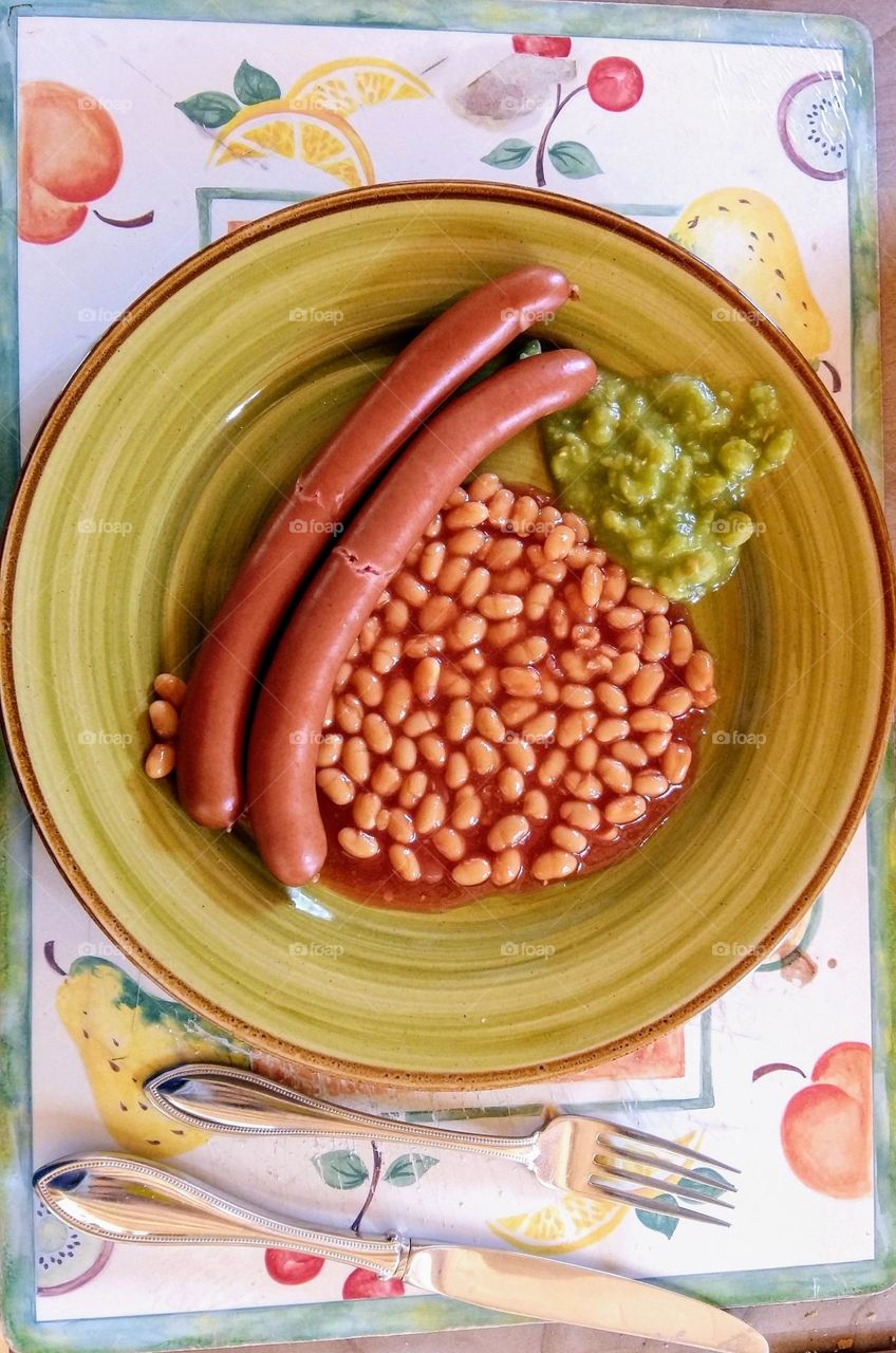 Typical irish food with beaked beans, sausages and peas