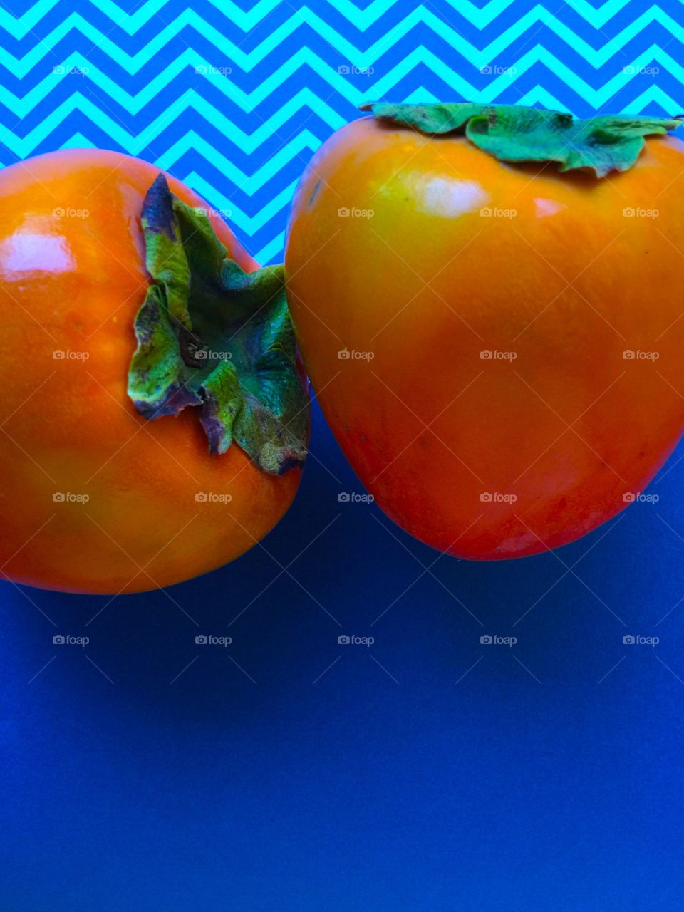 Persimmons on chevron background with copy space