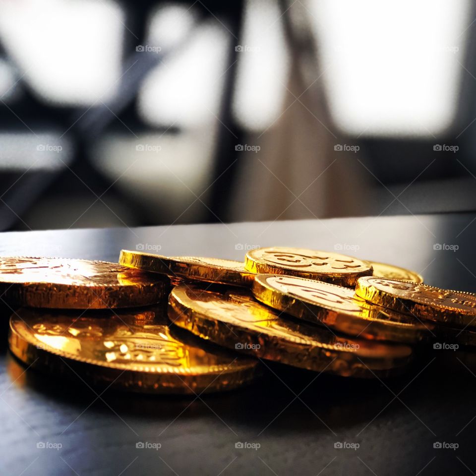 Chinese Gold chocolate coins on black wood table 