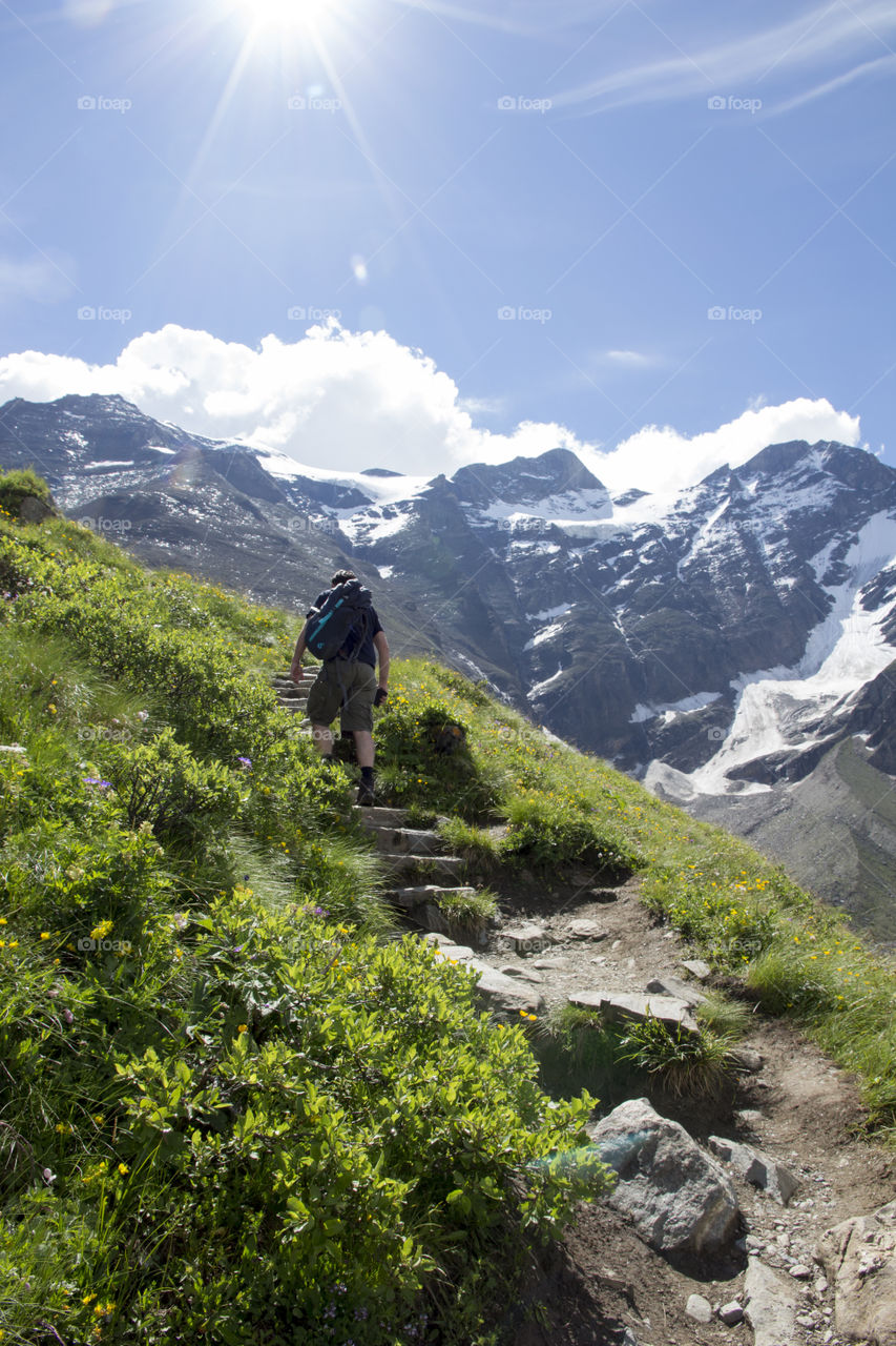 Man with backpack hiking in the mountains 