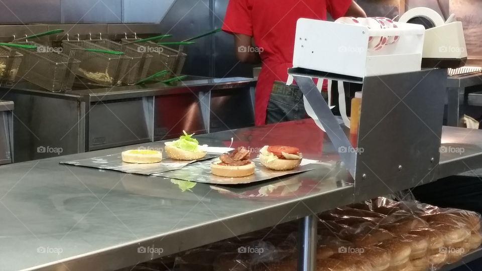 Food being prepared in fast food restaurant, burgers, blt