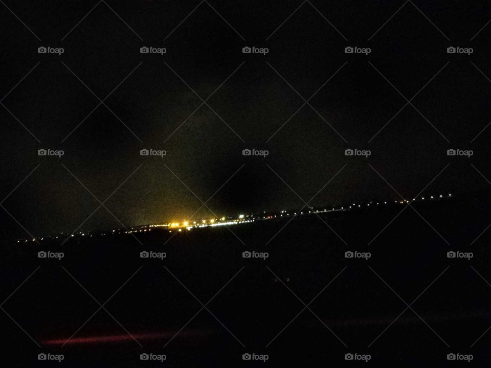 The scenery in the distance at night,  many small and continuous lights bring me a mysterious feeling. maybe is simple street lamps, maybe a bright city. but a mysterious beauty.