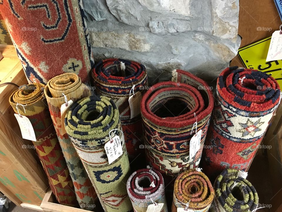 Rolled vintage rugs for sale.