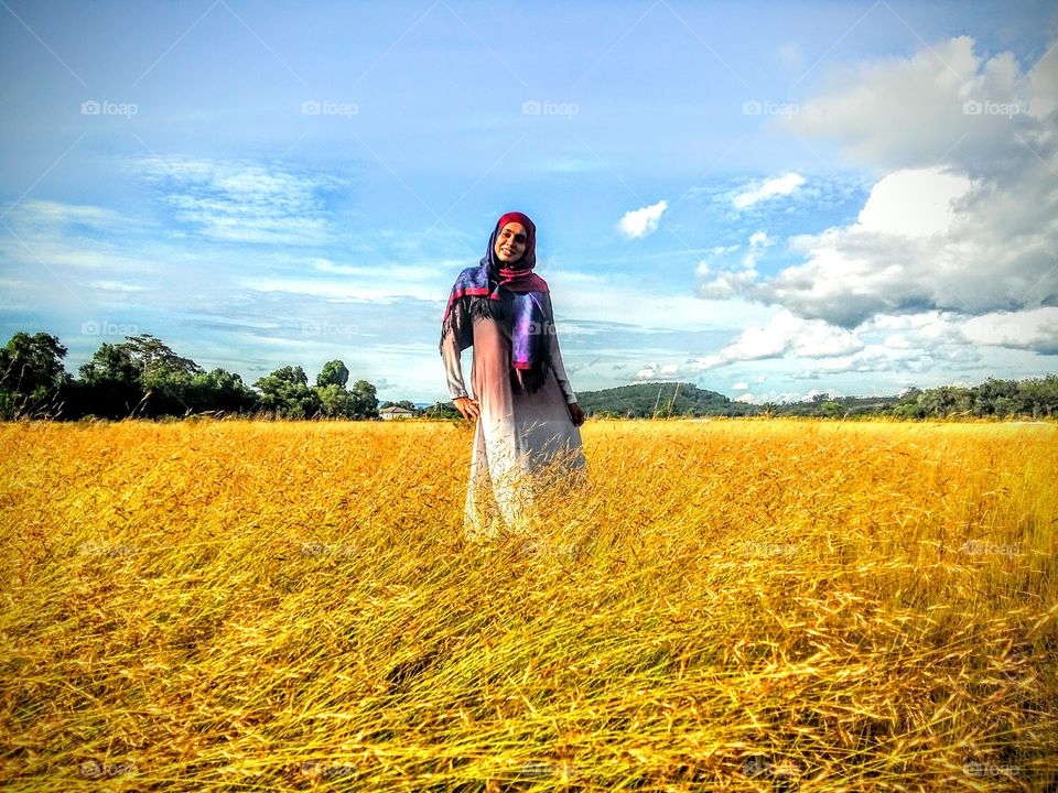 Portrait of a woman standing in field