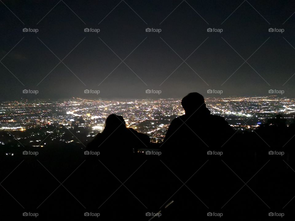 Doi suthep overlooking chiang mai at night, couple