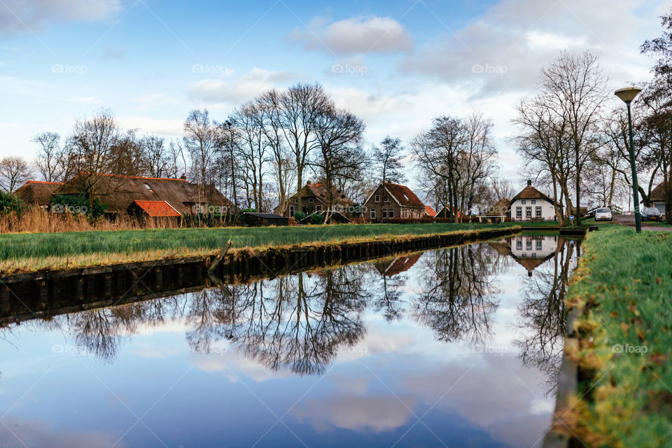 A clear water reflection of a beautiful sky and the nature in a countryside scenery 