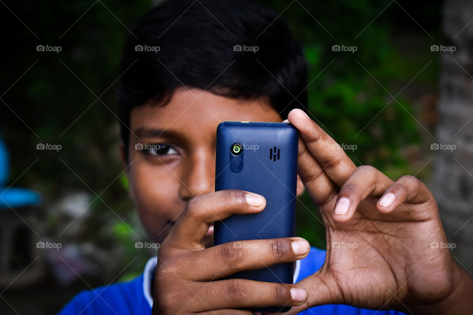 This picture is a self portrait style photography. It brings nostalgia about the phones we used to use    10 Years back , and how we used to cherish those small moments clicked with a 2 megapixel cameras , for both selfie and main pictures.