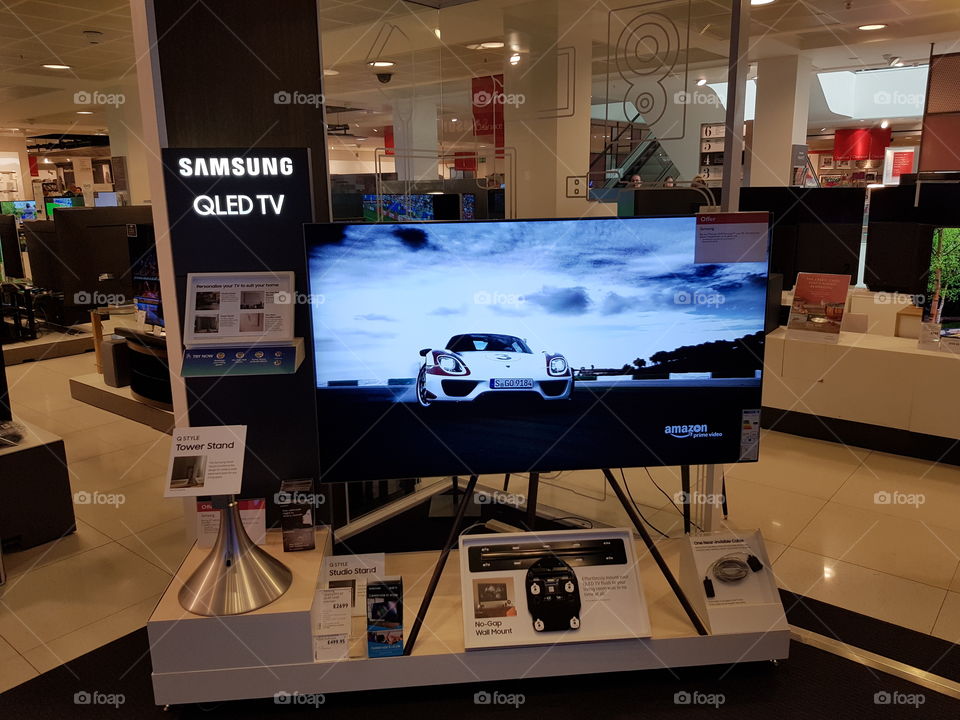 Samsung QE65Q7FN ambient mode television showcasing Tower and studio stand No gap wall mount