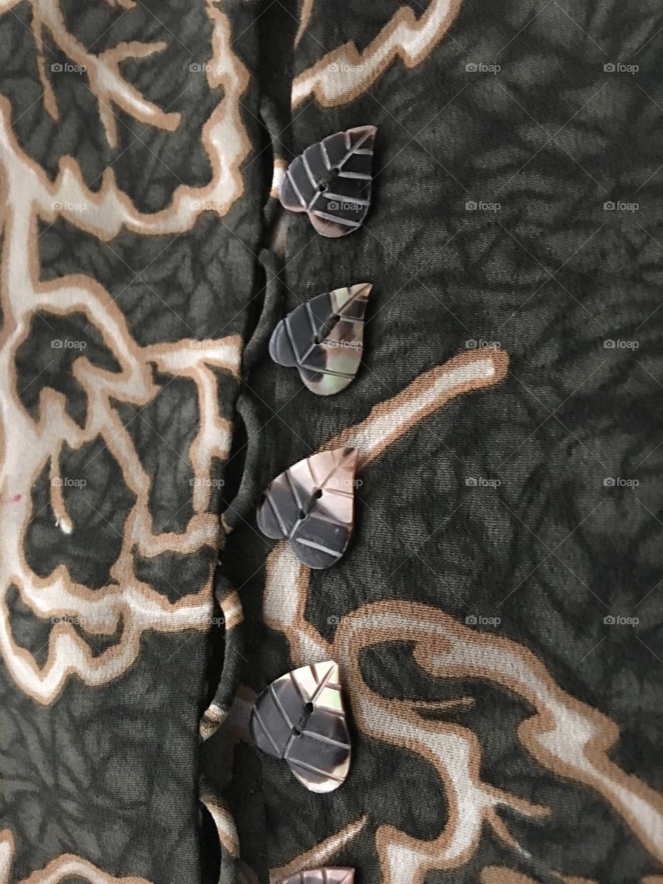 Shell leaf buttons on silk jacket 