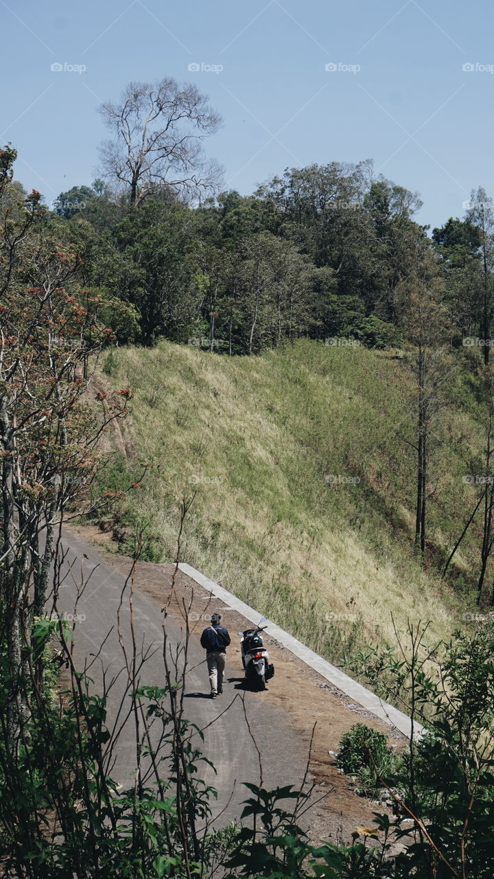 A motorcycle touring with my partner through an amazing hill in Bondowoso.