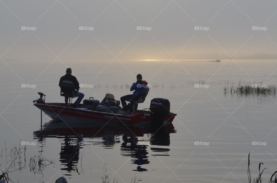The fishermen are already waiting for the fish early in the morning. There's a promise of morning in the distance, a thin sliver of gold started appearing on the edge of the silver lake. What a happy grey story! 