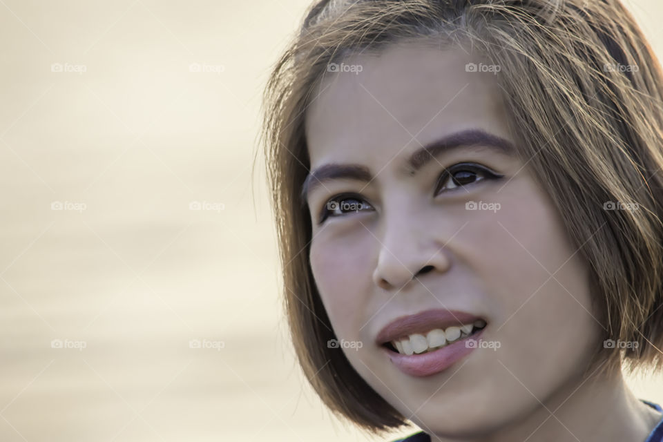 Portrait of Asian woman face smiling happily.