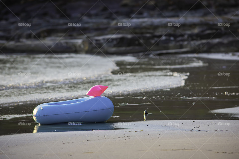 Blue Inflatable ring on the beach Background sea.