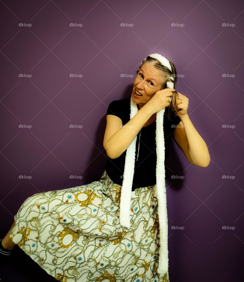 Funny woman curling her hair with the bathrobe method
