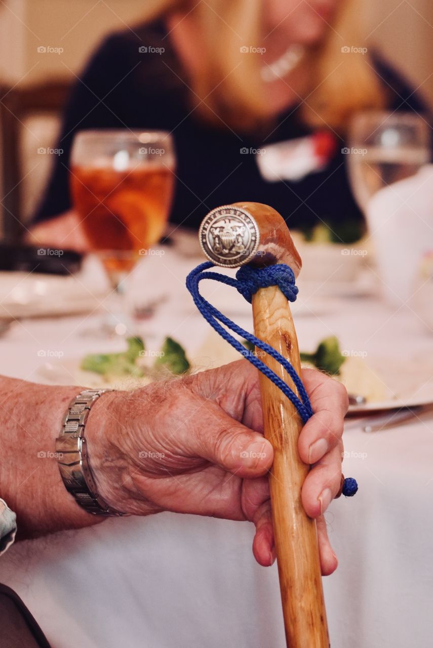 Veteran holding his custom carved  cane 