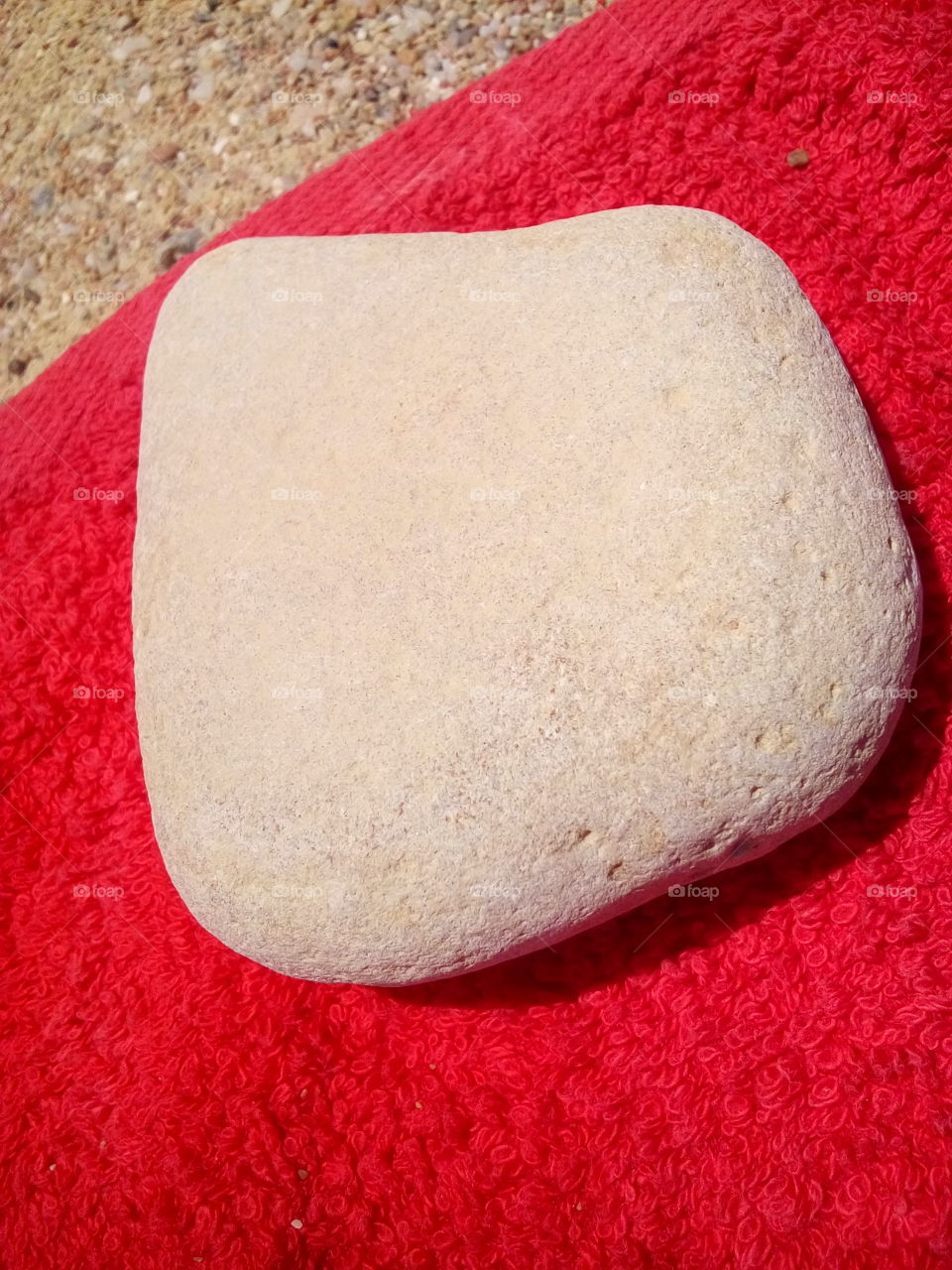 White Stone on Red Beach Towel