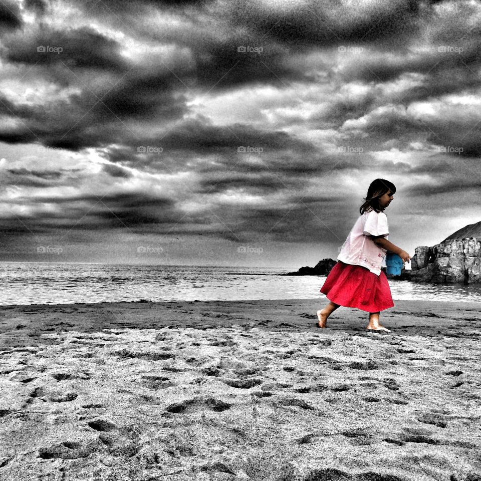 Little girl walking at beach