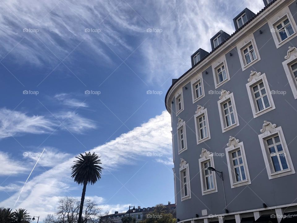 Various shapes of clouds in the sky and the blue building 