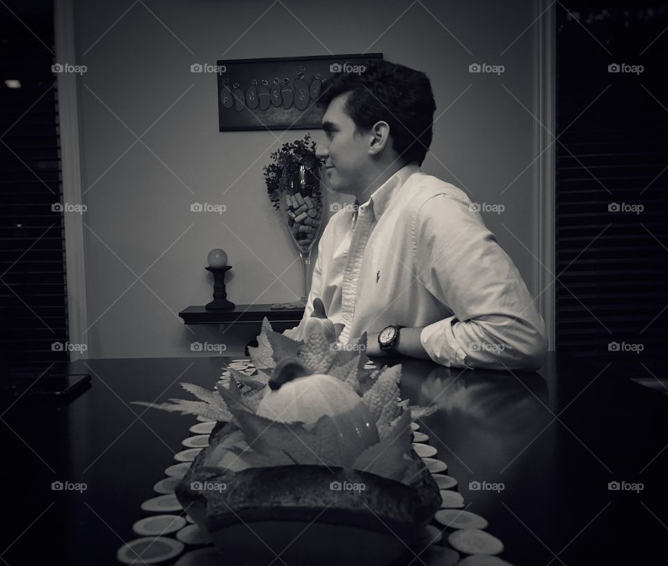 Man sitting on table with pumpkin runner