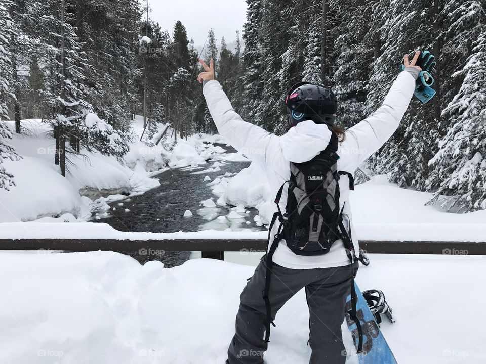 Snowboarder in the snow with arms in air