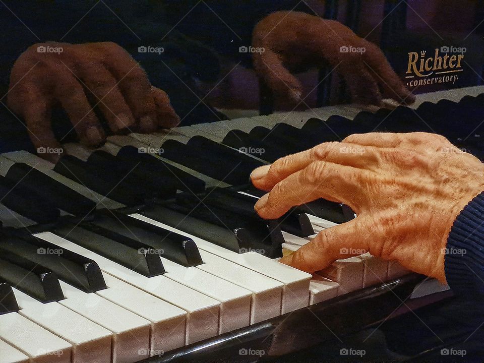 Old man plays on the pianoforte