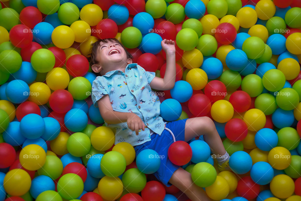 Boy happy in a Ball pool