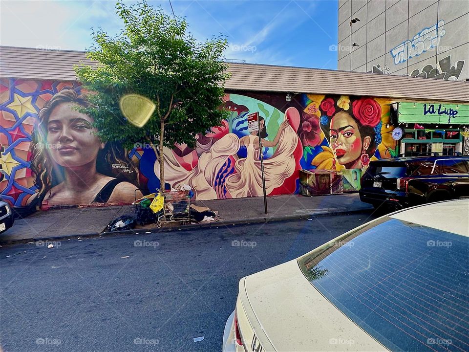 This is a lovely Latin inspired art mural on “Jefferson St” off “Broadway” and “Myrtle Ave” in “Bushwick”, Brooklyn next to the club restaurant “La Lupe” covering almost an entire city block. 2024. Hypnotic Productions