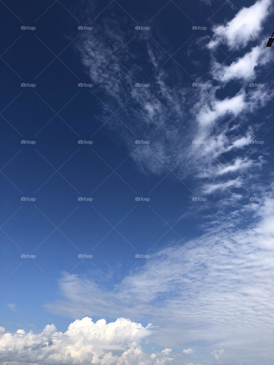 Deep blue sky with clouds.