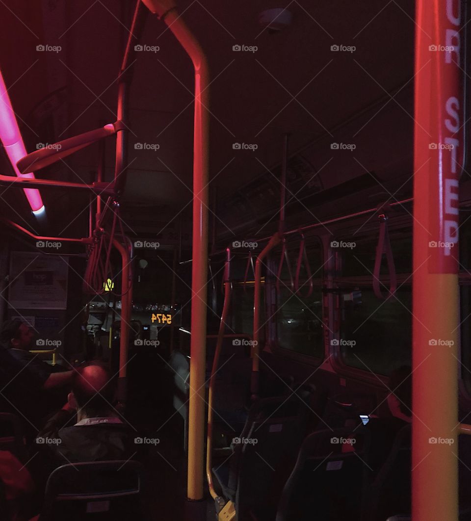 the bus at night with red lights.