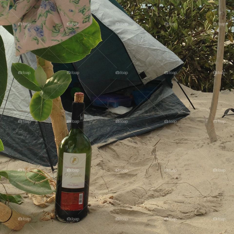 A bottle of wine. Camping and drinking wine