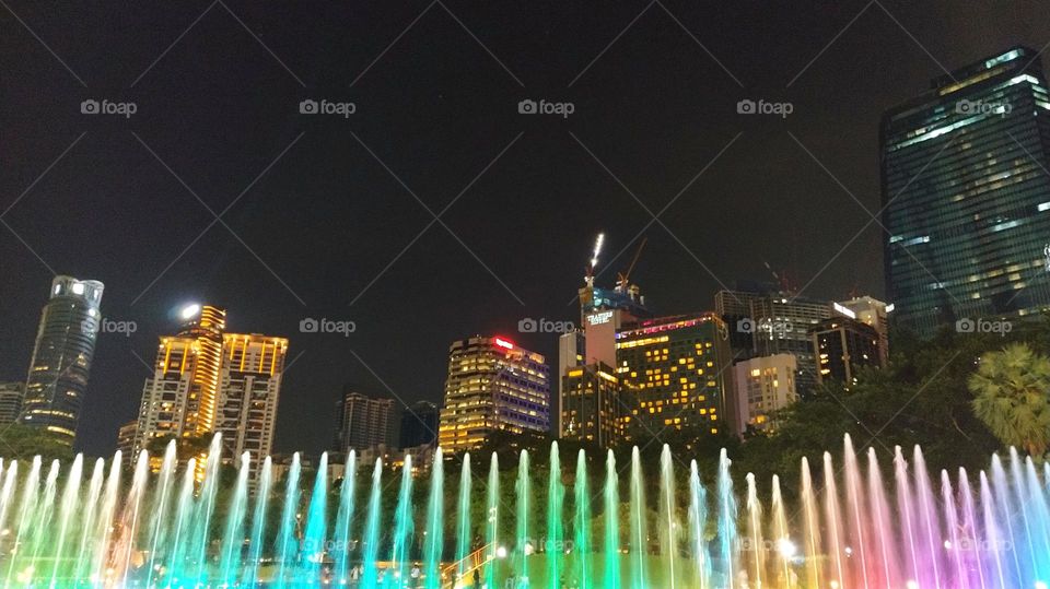 colourful water sprays at night in KLCC Malaysia