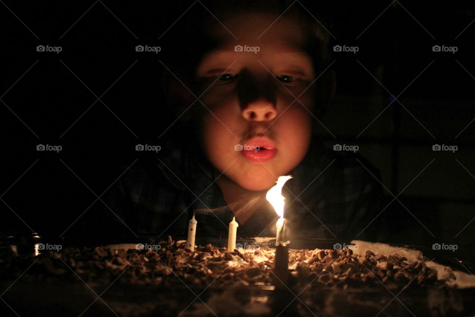 Girl blowing birthday cake