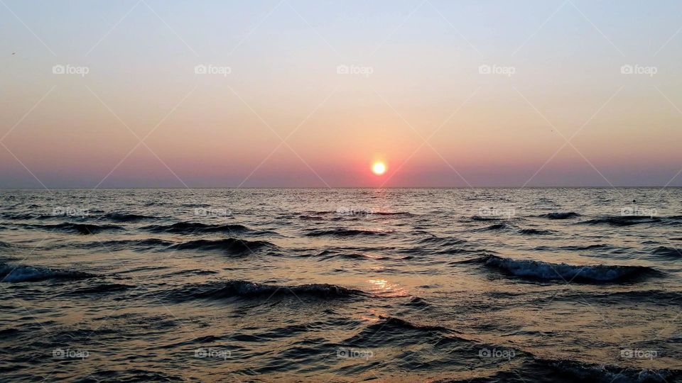 Calm sea during sunset.