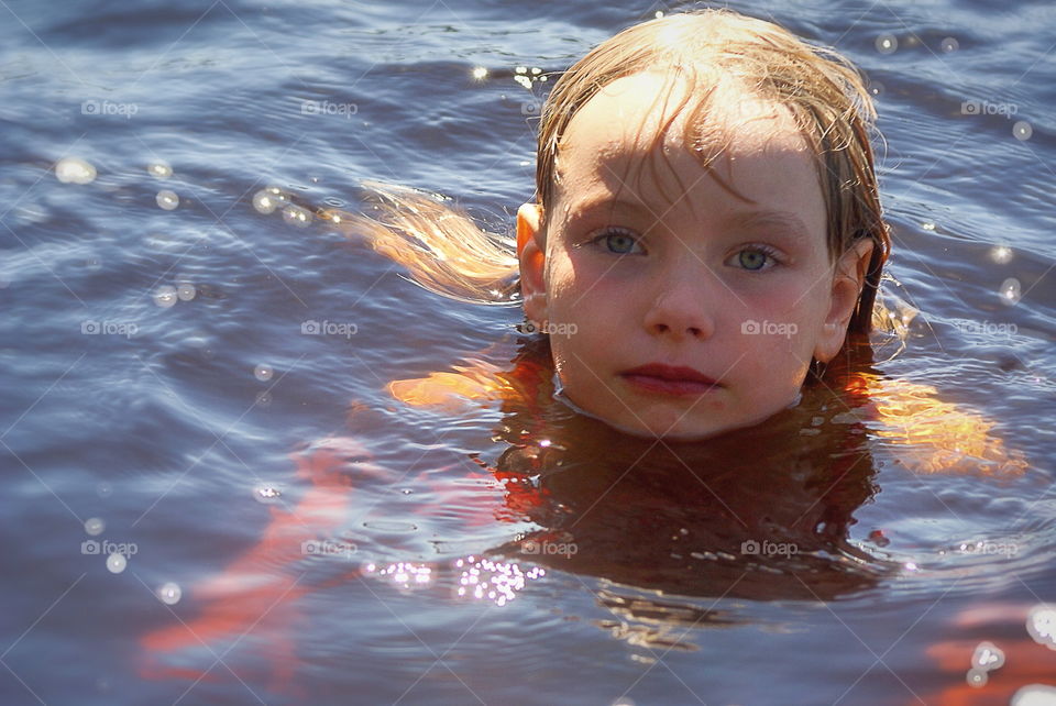 Child swimming in the lake