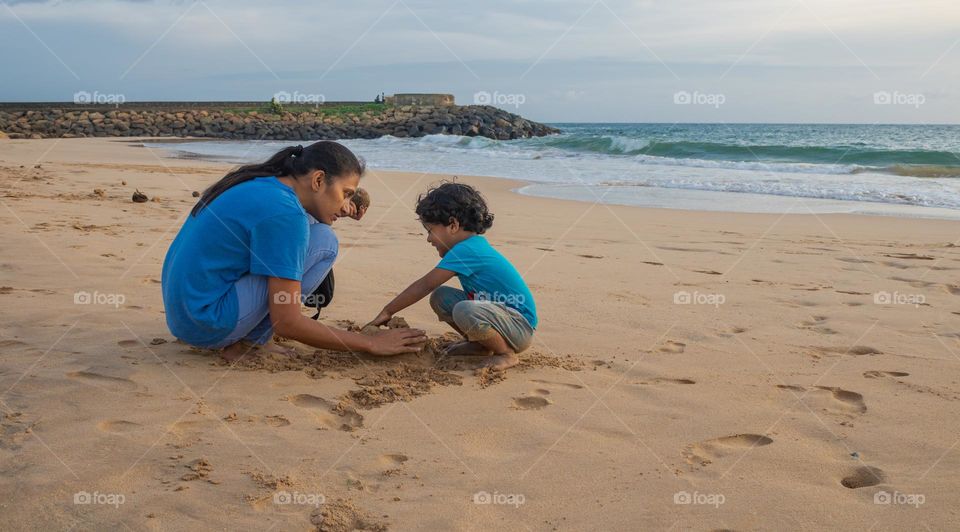 Playing with mother at beach, happiest moment for the child.