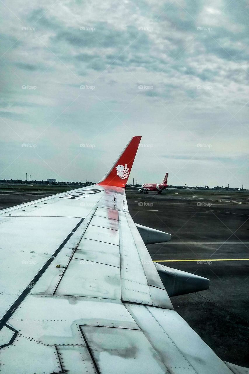 Airplane wing on the runway in eye level view