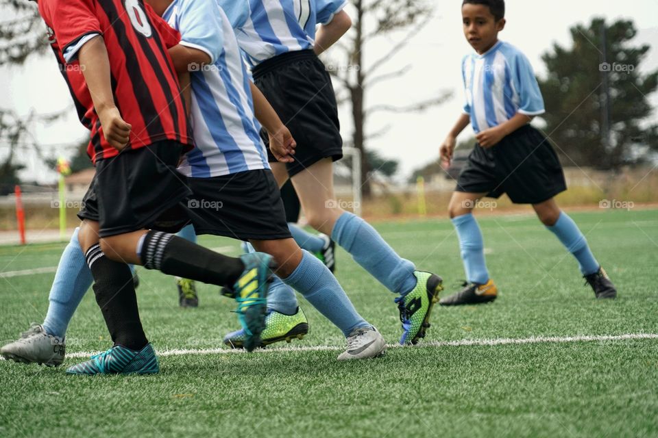 Feet Running On A Soccer Field