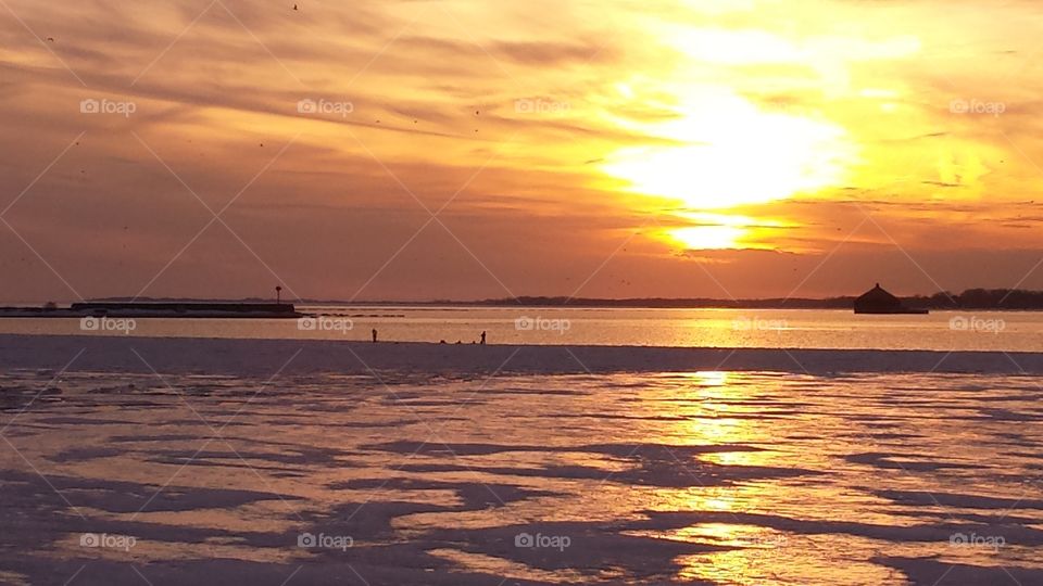 people walkin on water in sunset. sunset 