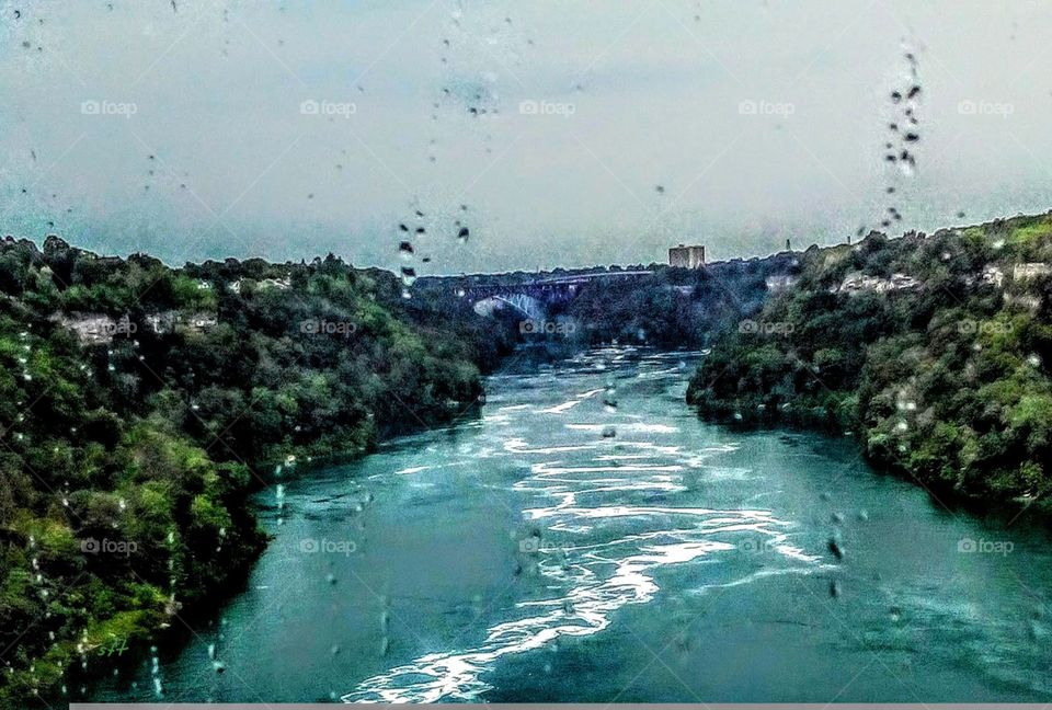 A river's water flow at raining, that white color was so nice and special different. blue river matched well with white curve.