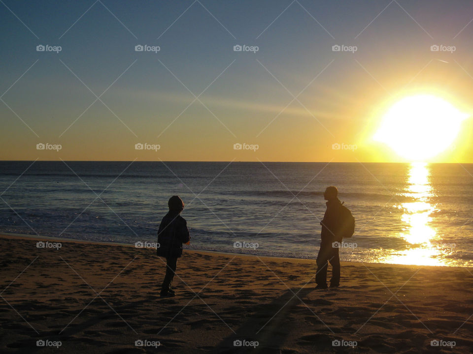 Super dad takes son to beach to catch a colorful sunset